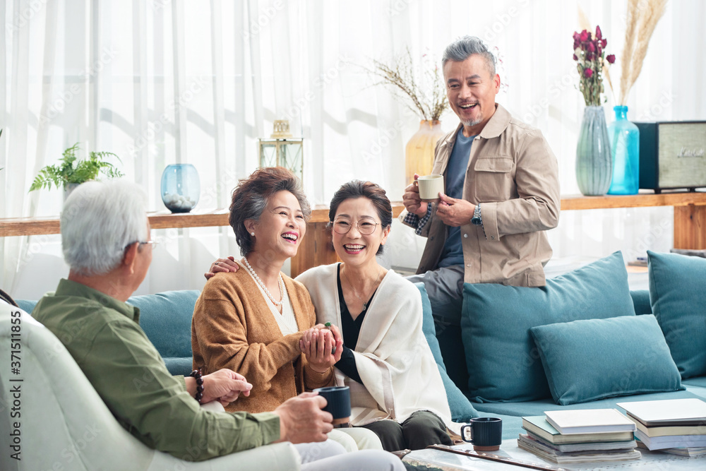 Happy elderly couple chat over a cup of tea Happy elderly couple chat over a cup of tea