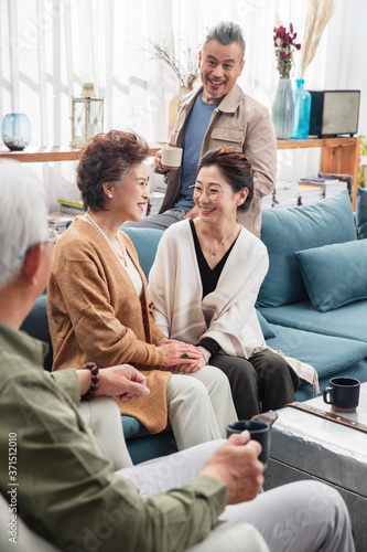 People drink tea in the living room to chat happy old age photo