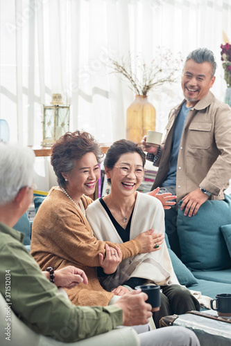 The elderly in happy chat over a cup of tea photo