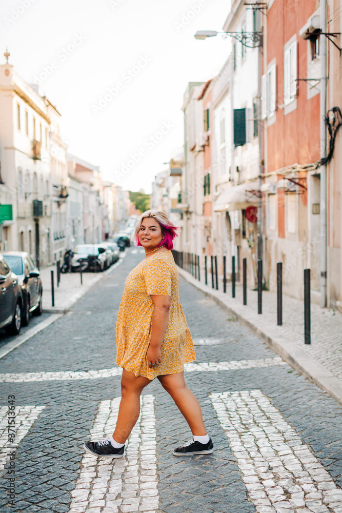 Fototapeta premium Young body positive woman crossing street in city