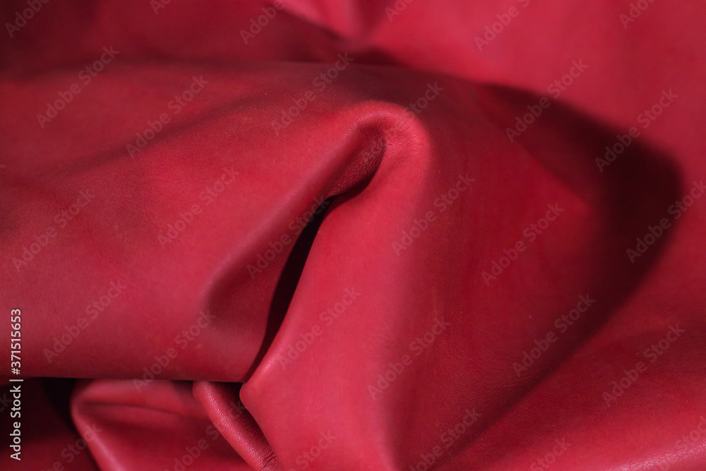 Red leather fabric folded irregularly. Red leather fabric folded irregularly.
