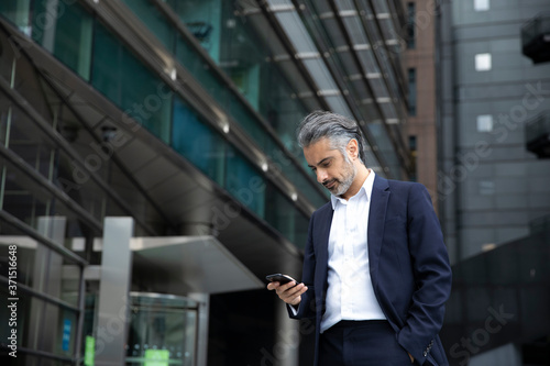 Wallpaper Mural Businessman using smart phone in city Torontodigital.ca