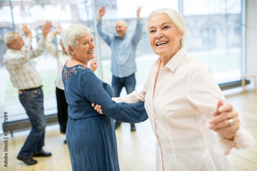 Group of active senior attending dance course in retirement home Group of active senior attending dance course in retirement home