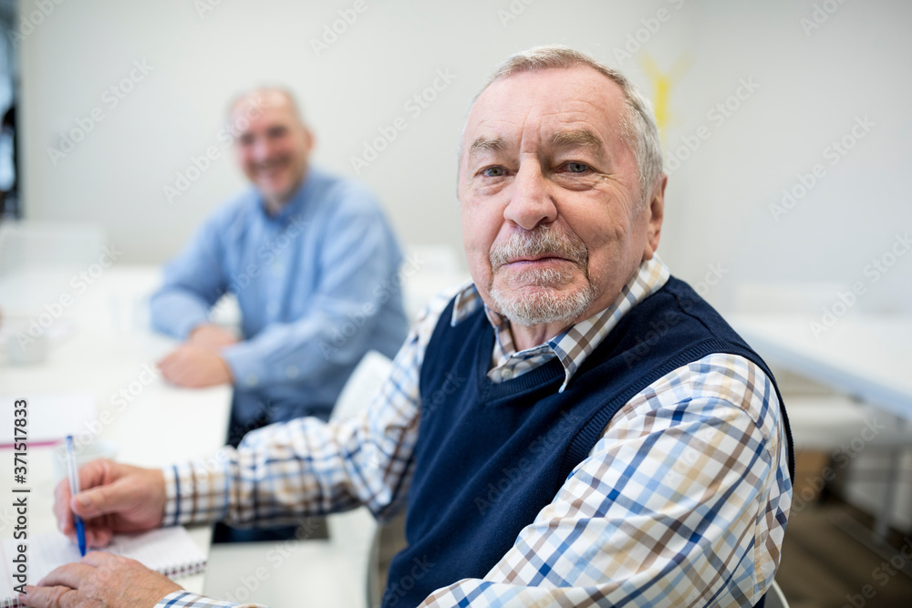 Senior man attending seniors education course Senior man attending seniors education course