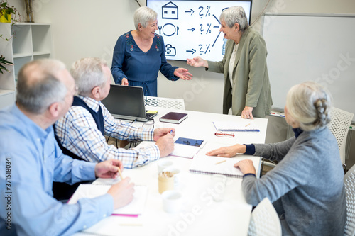 Senior instructor holding course on bool keepinf for seniors