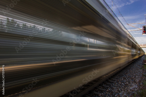 Train in movement by rail with a blue sky