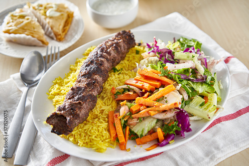 greek beef souvlaki platter with rice and pickled vegetables