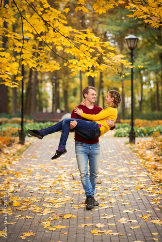 happy young couple having fun and walking in the autumn Park