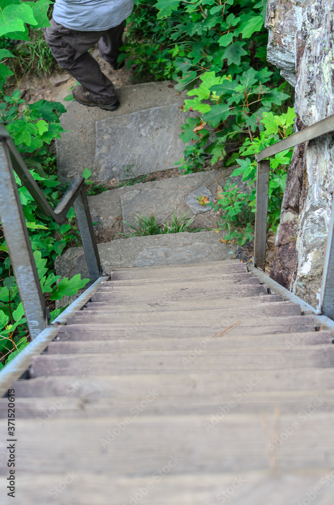 traveler at the base of wooden stairs along high falls trail in the talladega national forest, alabama, usa