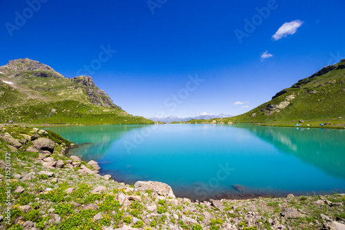 Alpine mountain lake at the daytime, sunlight and colorful landscape © taidundua