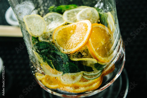 lemonade dispenser with mint and lemon and orange wedges