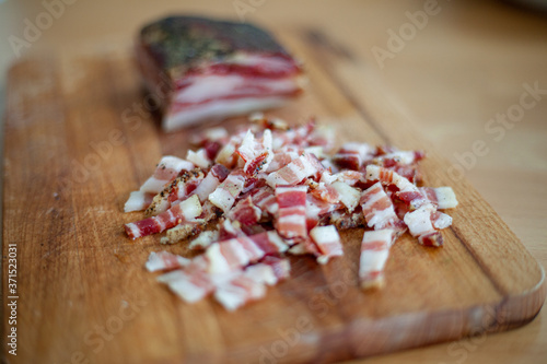 Pancetta e guanciale tagliati a strisce per aperitivo o snack a base di taglieri di salumi e formaggi photo