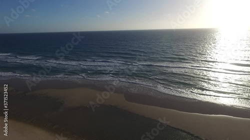 Aerial View of a Beach in Porto das Dunas Ceará Aquiraz Brazil Sunny Day Waves Blue Sky  photo