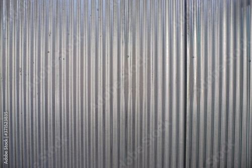 Pattern on a shiny steel plate and is often used as a barrier to a building project.