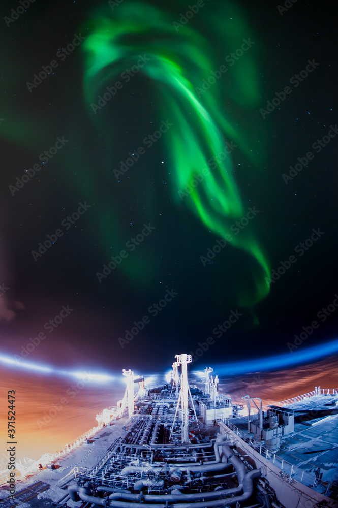 Aurora borealis and LNG vessel at the night