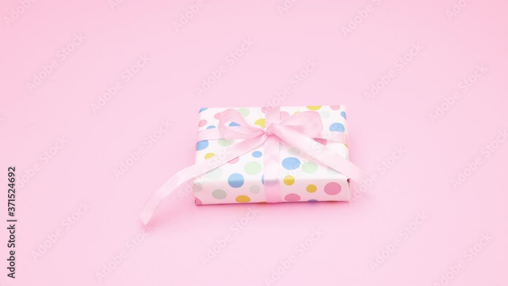 Stop motion animation of tying bow on little gift. Stop motion animation of tying bow on little gift.