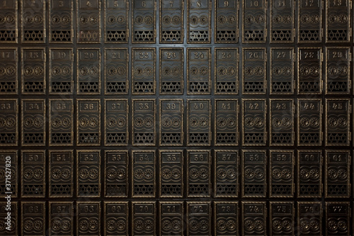 Textured background of vintage numbered mail boxes
