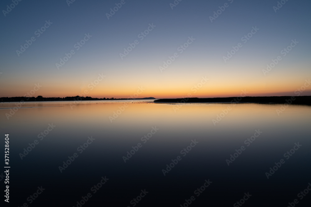 Long exposure summer sunset over lake in Sweden.