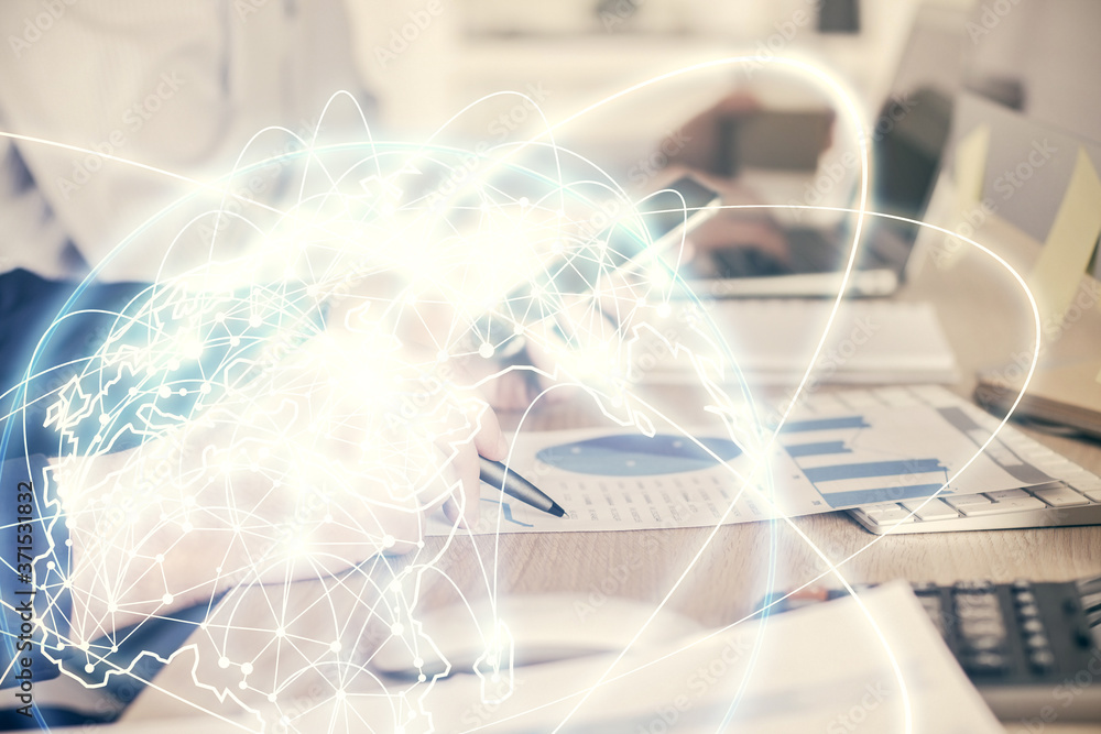 Double exposure of man's hands holding and using a phone and international business theme drawing. Double exposure of man's hands holding and using a phone and international business theme drawing.