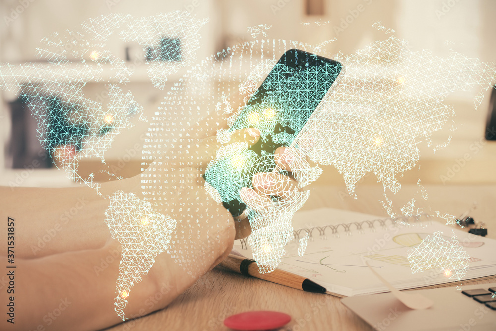 Double exposure of man's hands holding and using a phone and international business theme drawing. Double exposure of man's hands holding and using a phone and international business theme drawing.