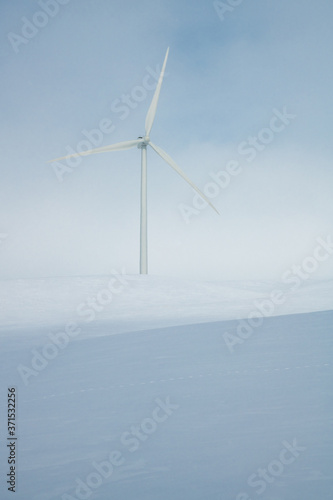 Windmills in Snow Covered Fields in Winter