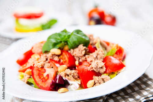 Salad with tuna, tomato, peanuts and fresh basil