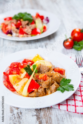 cooked meat with tomatoes and potatoes