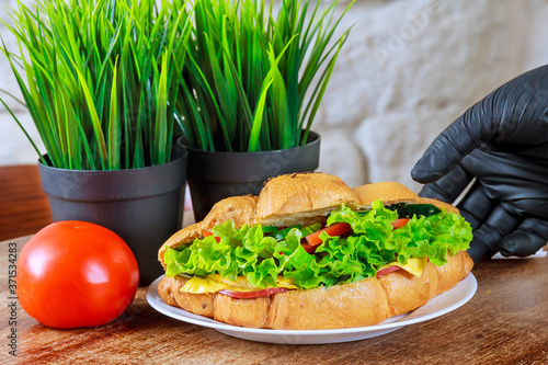 Fresh croissant with ham and salad leaf with sfresh salad. photo