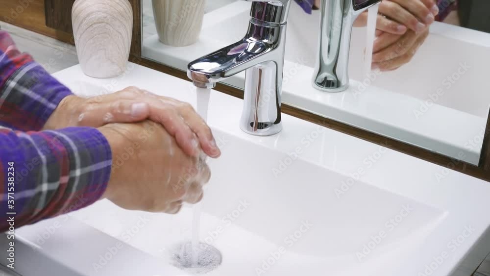 Stockvideon Wash hands under a tap with water, wash off dirt,closeup