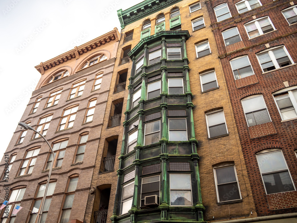 Fototapeta premium classic brick building facade with bow windows