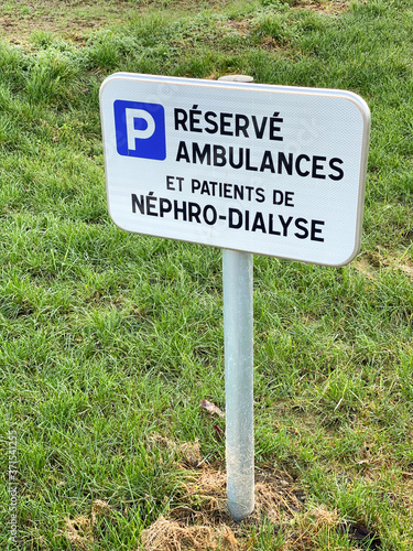 French sign at the hospital translated as Reserved for ambulances and patient of nephro-dialyzed