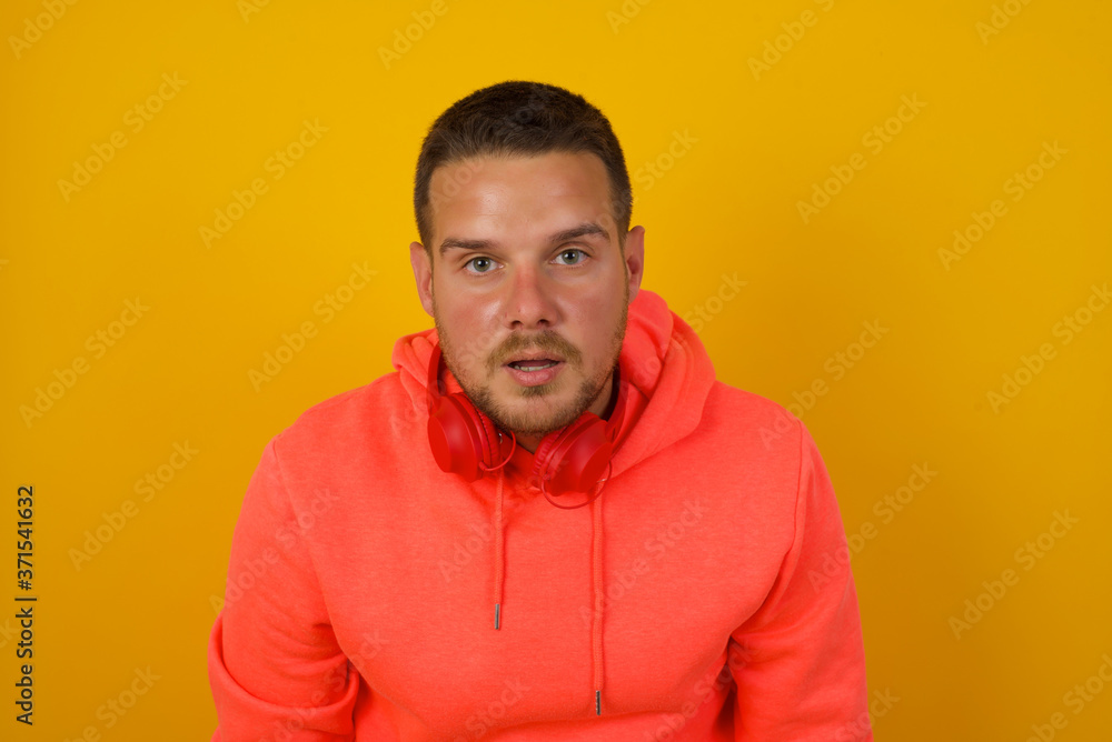 Attractive young man having stunned and shocked look, with mouth open and jaw dropped, listening to friend's story in full disbelief, exclaiming: Wow, I can't believe this. Surprised boy. Shock Attractive young man having stunned and shocked look, with mouth open and jaw dropped, listening to friend's story in full disbelief, exclaiming: Wow, I can't believe this. Surprised boy. Shock