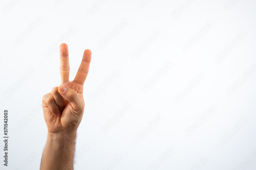 hand making the peace sign on a white background with high key effect hand making the peace sign on a white background with high key effect