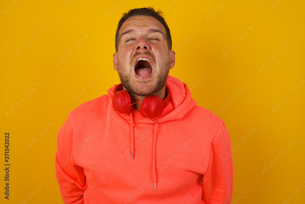 Stressful hipster man screams in panic, closes eyes in terror, keeps hands on head, finds out terrified news or disaster about best friend, can't believe it. People, stress, annoyance Stressful hipster man screams in panic, closes eyes in terror, keeps hands on head, finds out terrified news or disaster about best friend, can't believe it. People, stress, annoyance
