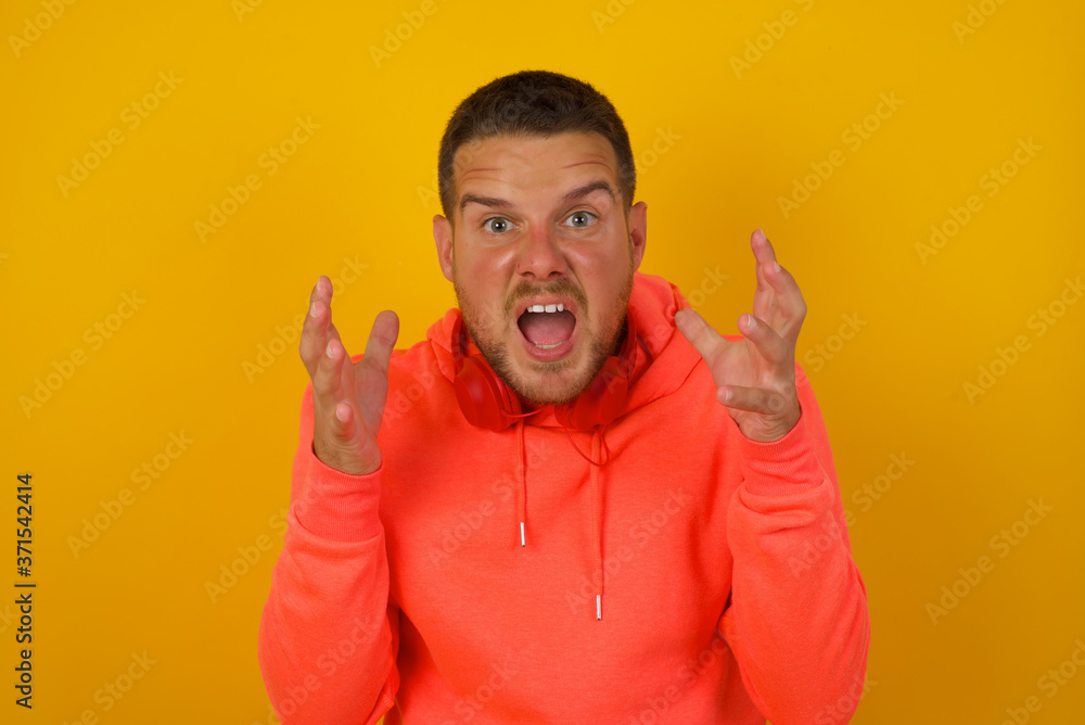 Screaming, hate, rage. Crying emotional angry man screaming on blue studio background. Emotional, young face. Female half-length portrait. Human emotions, facial expression concept. Trendy colors Screaming, hate, rage. Crying emotional angry man screaming on blue studio background. Emotional, young face. Female half-length portrait. Human emotions, facial expression concept. Trendy colors