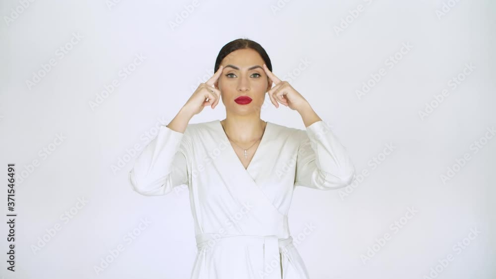 girl in white on a white background points with her fingers to her forehead on the eyebrows of the location of wrinkles to the head girl in white on a white background points with her fingers to her forehead on the eyebrows of the location of wrinkles to the head