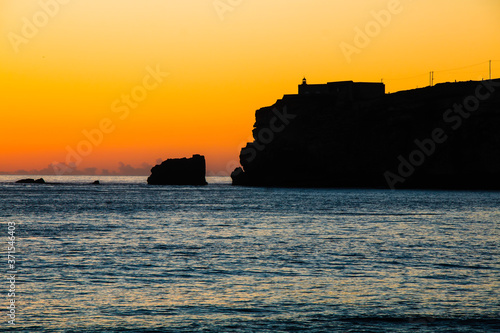 Beautiful sunset at the beach in the village of Nazare, Portugal