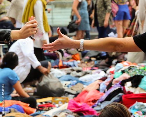 Money changing hands at a suitcase rummage, or clothing swap