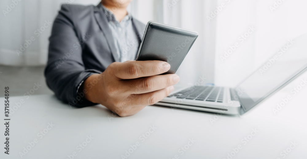 businesswoman hand using smart phone,mobile p payments online shopping,omni channel,digital tablet docking keyboard computer at office in sun light businesswoman hand using smart phone,mobile p payments online shopping,omni channel,digital tablet docking keyboard computer at office in sun light