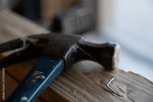 Damaged wood and bent nail from being hit at an angle photo