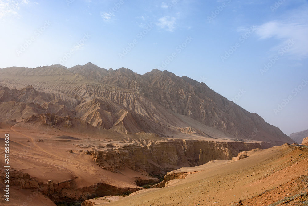 Flaming Mountains or Gaochang Mountains are barren, eroded, red sandstone hills near Turpan, Xinjiang, China Flaming Mountains or Gaochang Mountains are barren, eroded, red sandstone hills near Turpan, Xinjiang, China