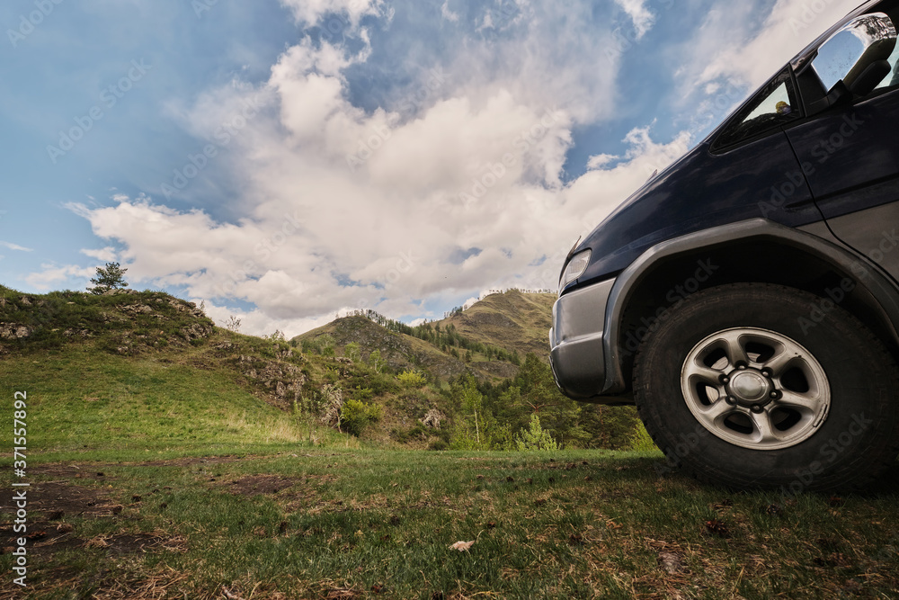 Off road car travel in beautiful high mountains, summer sunny day