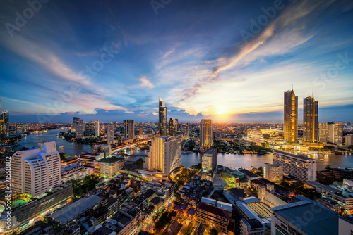 Cityscape in Bangkok city from roof top bar in hotel with Chao phraya river background