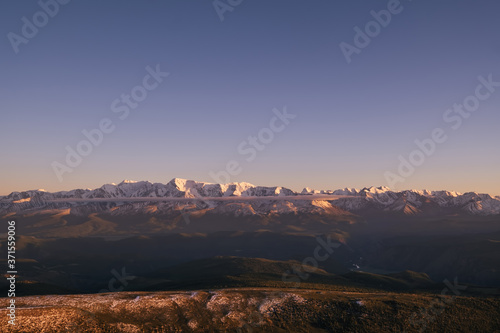 sunset over the North Chuysky ridge, amazing mountain landscape with snow peaks