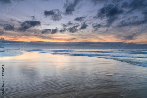 Sunrise Seascape with Clouds and Ships on the Horizon