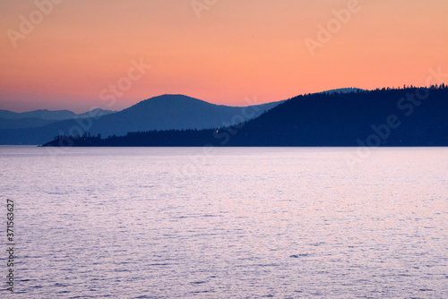 sunrise over lake Tahoe with different shaded mountains and orange red sky