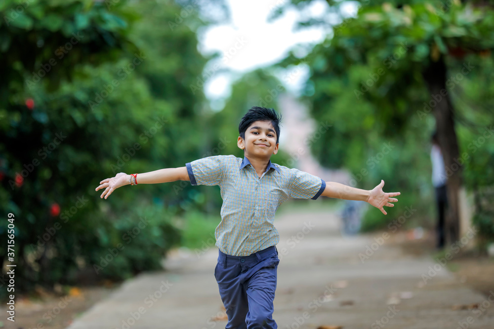 Indian School boy running at playground Indian School boy running at playground