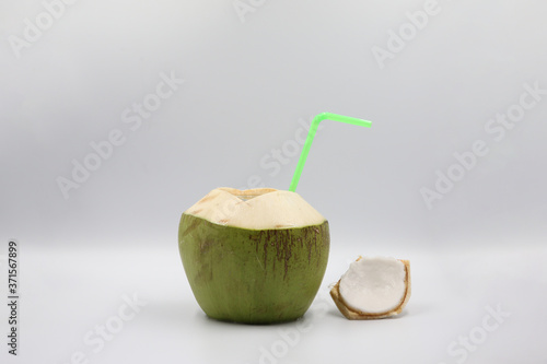 Fresh Green Coconut with Drinking Straw Isolated.  Summer Beverage Concept with White Background.