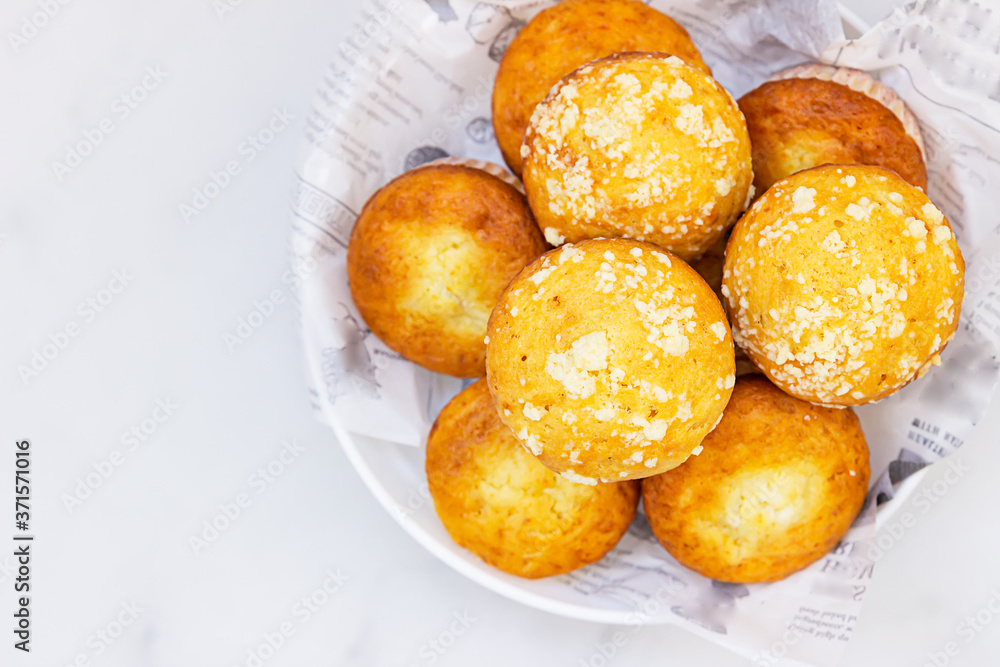 Freshly baked tasty vanilla muffins and muffins with crumble topping. Light background. Freshly baked tasty vanilla muffins and muffins with crumble topping. Light background.