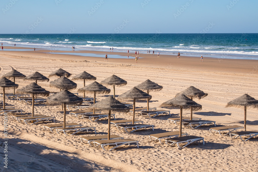 Parasols and hammocks on La Barrosa beach in Sancti Petri, Cadiz, Spain Parasols and hammocks on La Barrosa beach in Sancti Petri, Cadiz, Spain